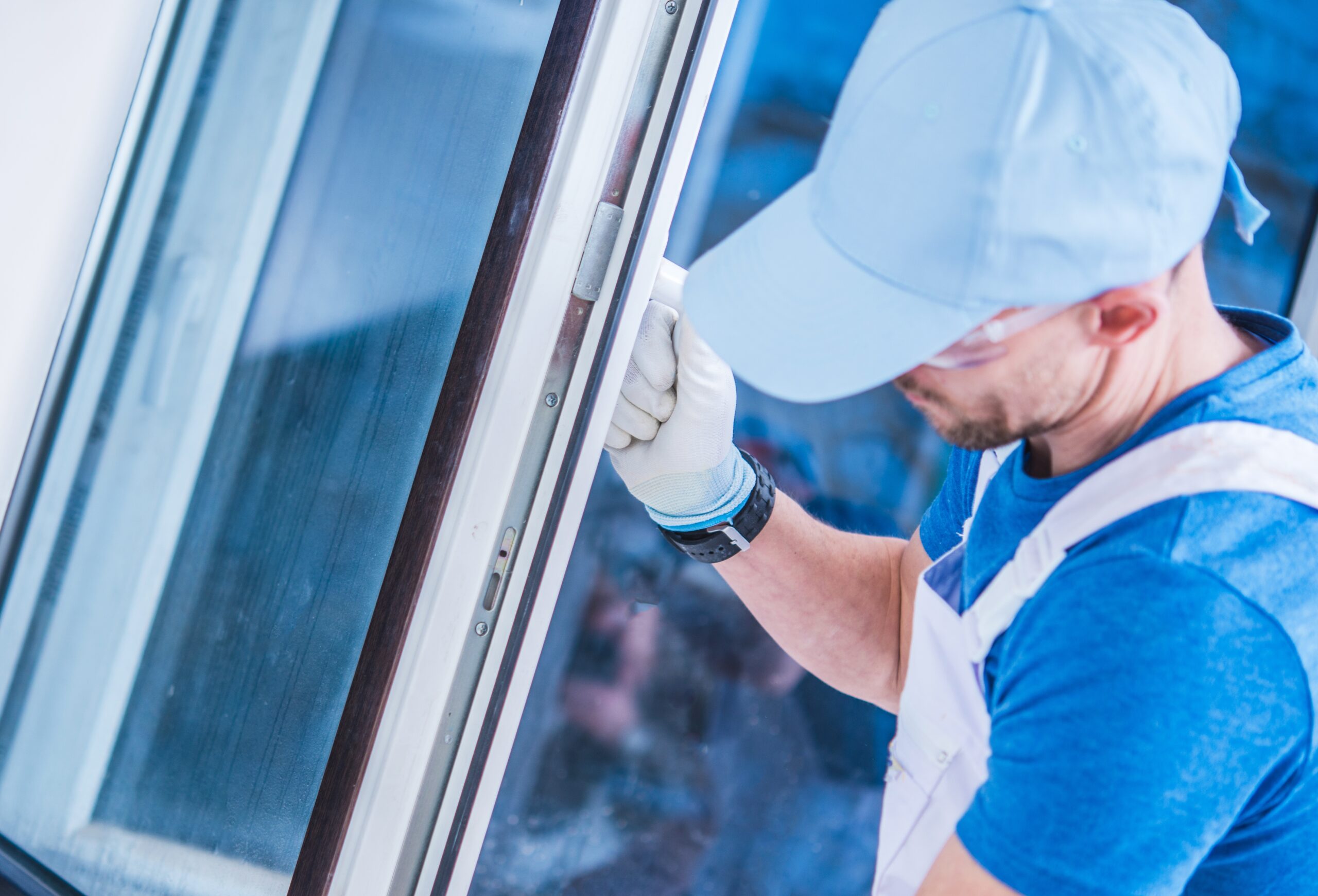 Caucasian Windows Technician Making Sure the Window is Installed Correctly.